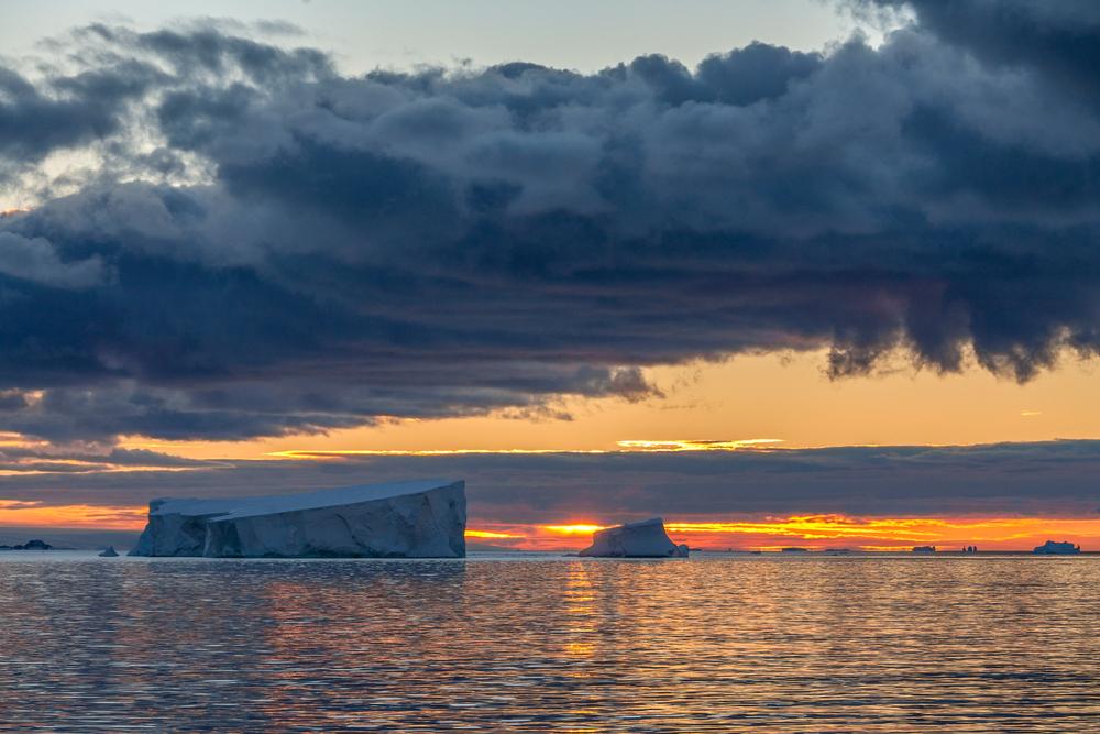 The midnight sun over the icebergs of the Drake Passage, Antarctica, Chile