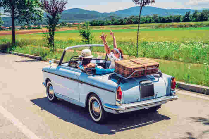 Two people driving a rental car 
