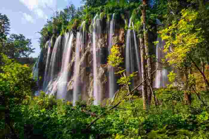 Waterfalls cascading over rocky cliffs in Plitvice Lakes National Park