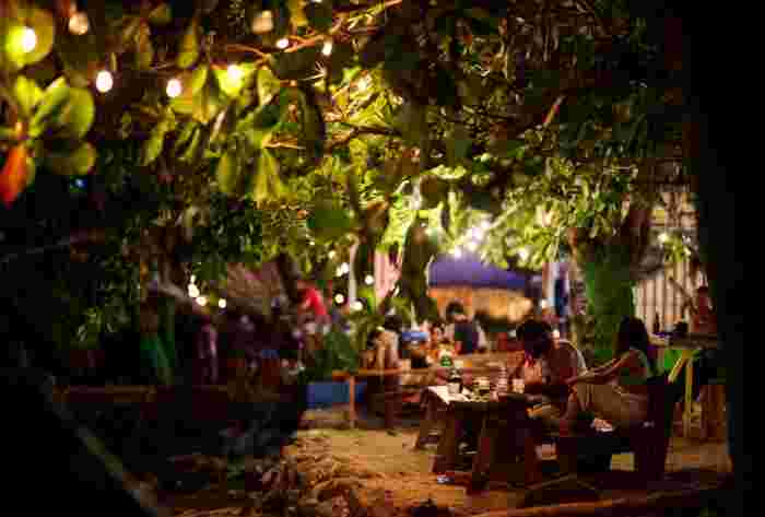Open-air beachside restaurant in Costa Rica at night with warm lights hanging in the trees