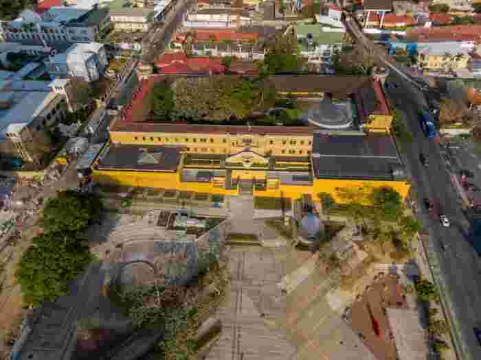 Aerial view of the National Museum of Costa Rica with its yellow colonial building and courtyard