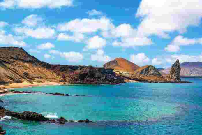 Crystal-clear turquoise waters and volcanic rock formations at Bartolomé Island in the Galápagos Islands, Ecuador 