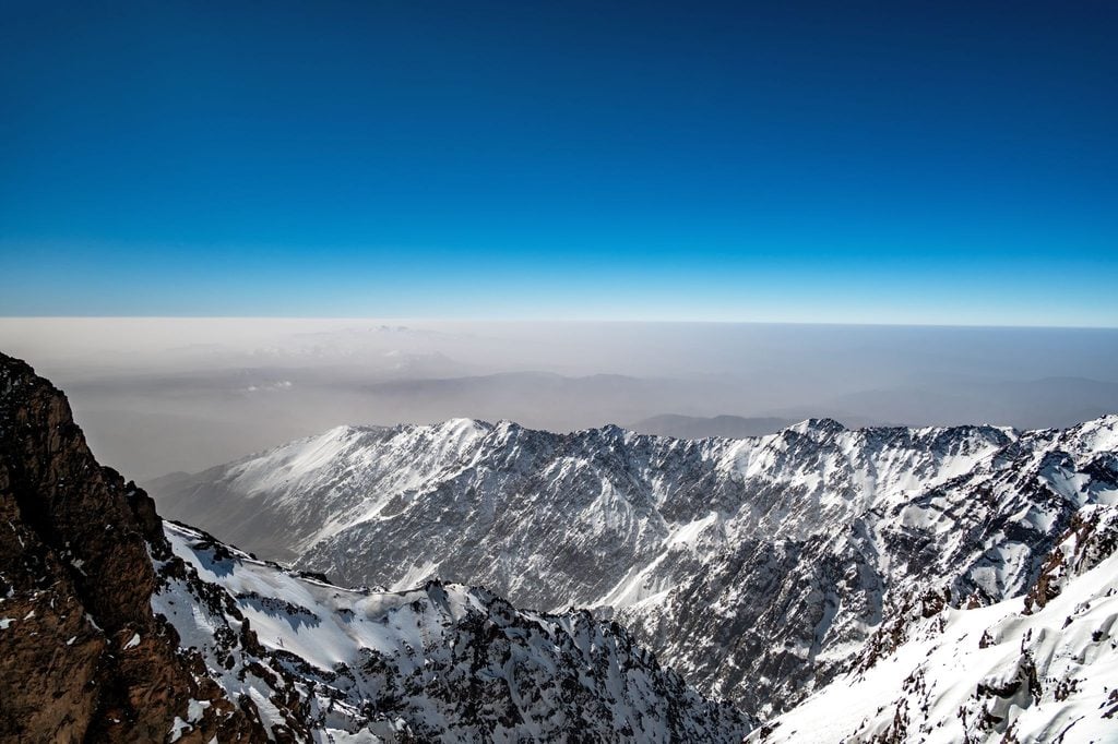 Snow-covered peaks of the High Atlas Mountains under a clear blue sky 