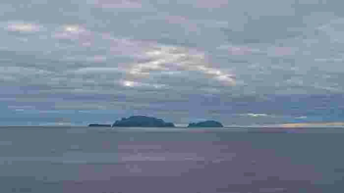 Distant,View,Of,The,Desertas,Islands,Silhouetted,On,The,Horizon Distant view of the Desertas Islands silhouetted on the Atlantic Ocean near Madeira, Portugal